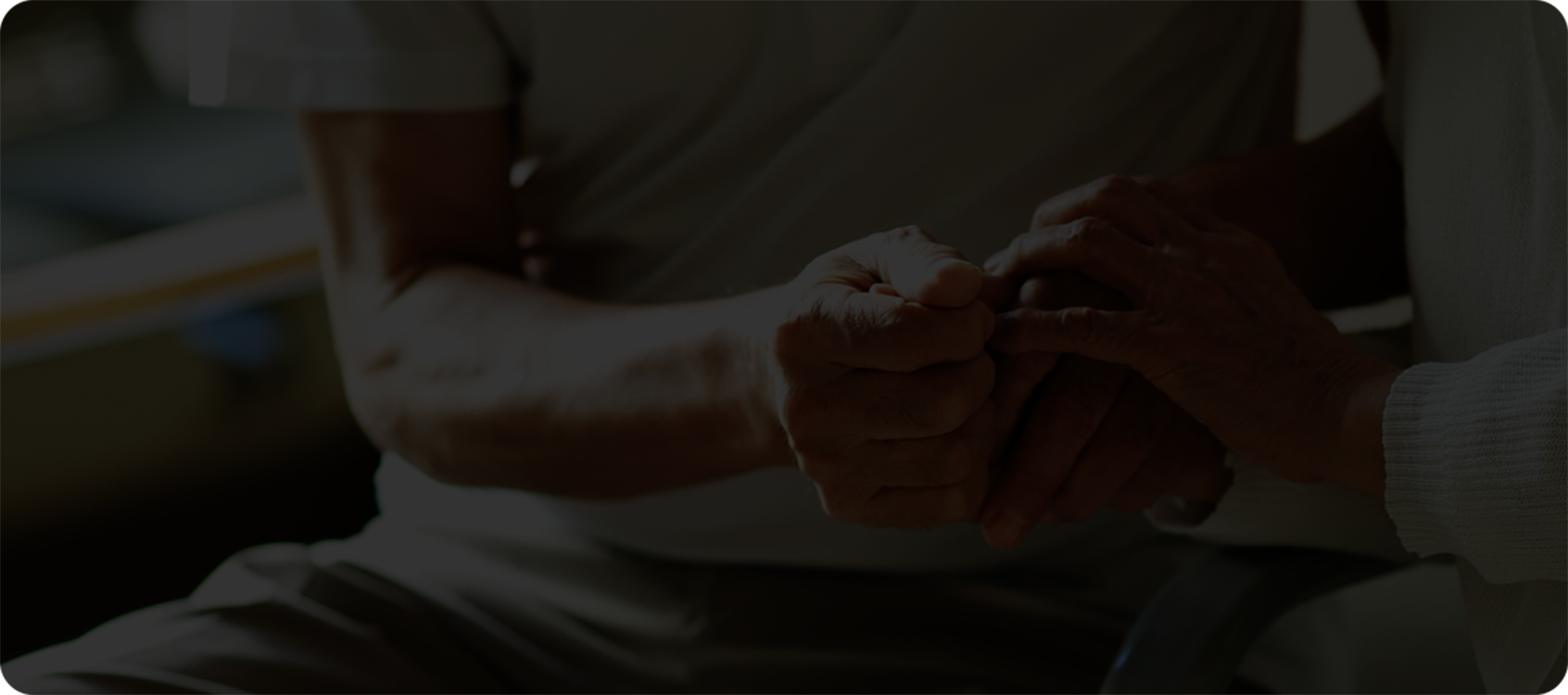 Gros plan sur deux personnes assises l’une en face de l’autre en se tenant les mains